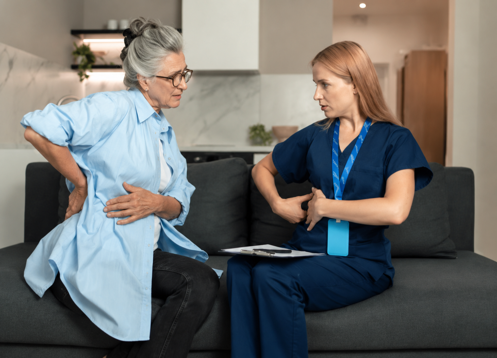 Senior Woman Discussing Back Pain with a Home Healthcare Nurse